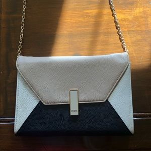 Brand:Guess  Size:Approximately 7”H x 10.50”L Color:Black, tan, and off-white